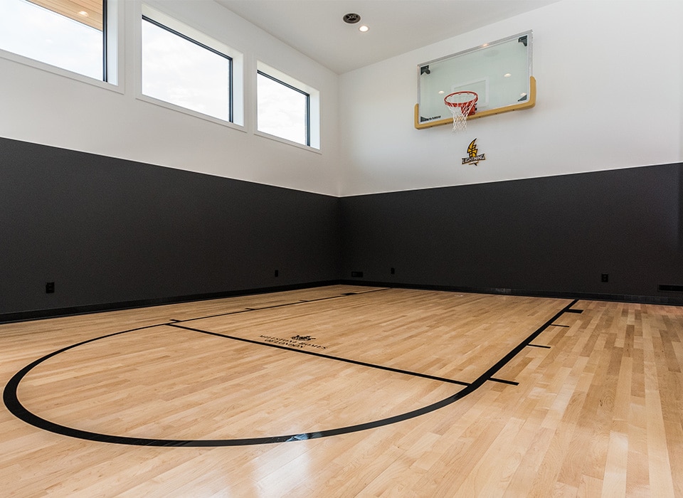 Hardwood basketball flooring installation in residential indoor court in London, Ontario