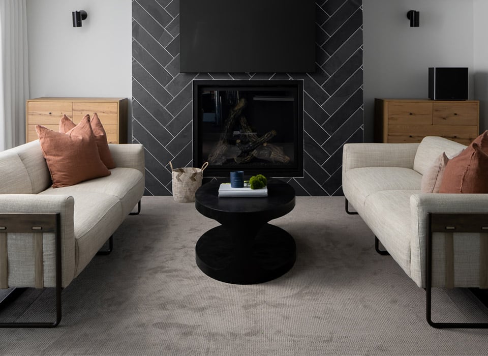 Soft taupe carpeting in a contemporary family living room with fireplace.