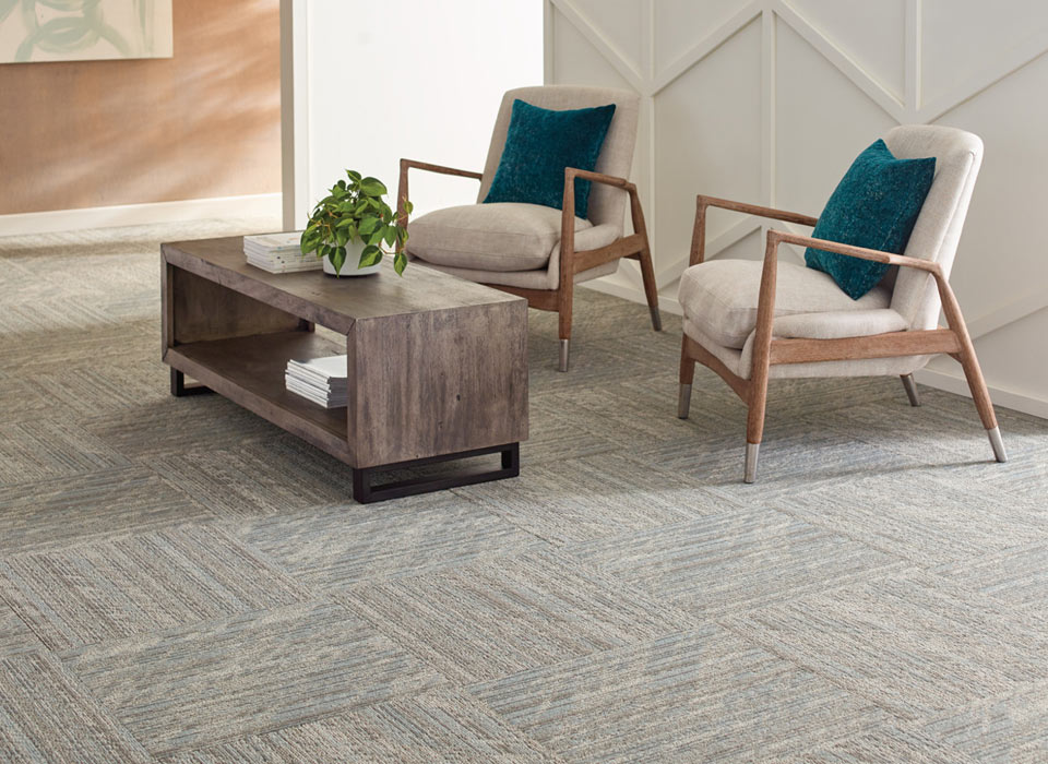 Stylish sitting area with modular carpet tiles in geometric layout.