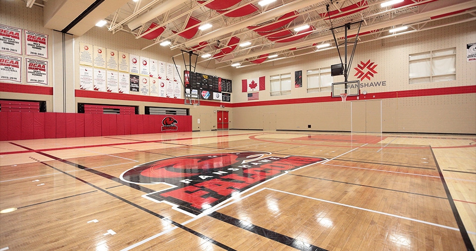 Gymnasium hardwood flooring with Fanshawe College logo and sports court lines in London Ontario