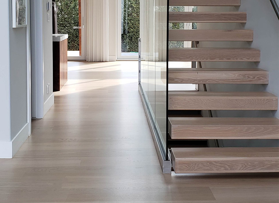 Beautiful hardwood flooring with floating staircase in modern home by Flatout Flooring, London Ontario.
