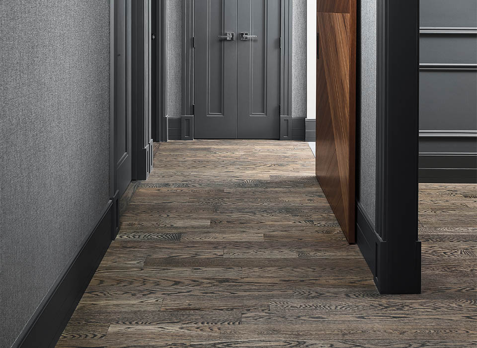 Refinished dark hardwood flooring in luxury hallway London Ontario