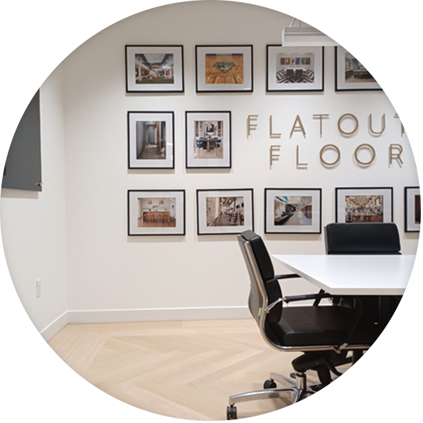 Flatout Flooring consultation office interior with framed portfolio wall in London Ontario