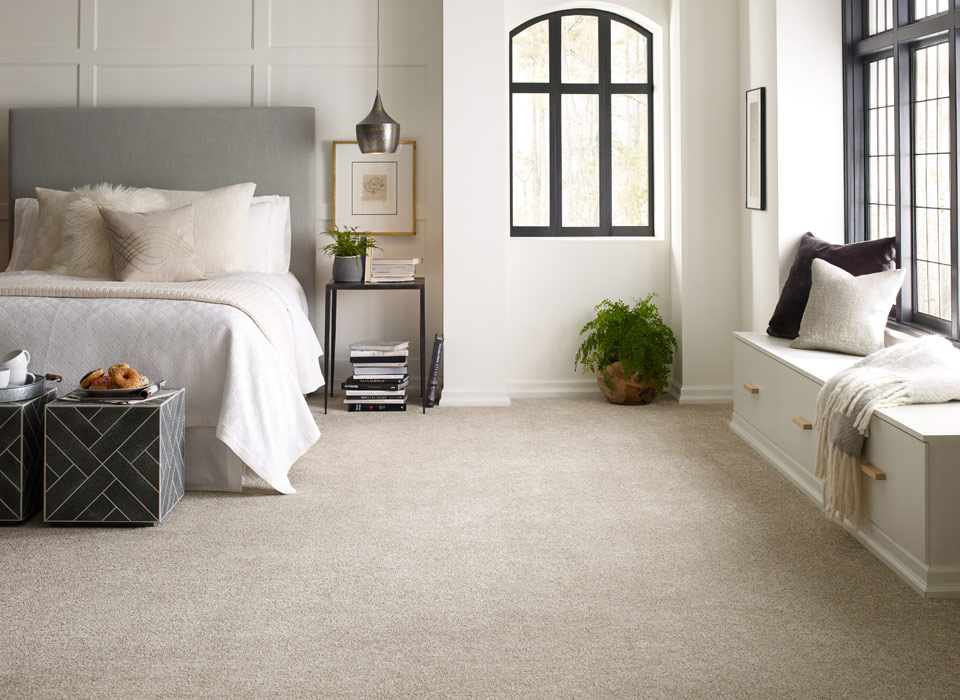 Cozy bedroom with plush beige wall-to-wall carpet installed in Ontario home.