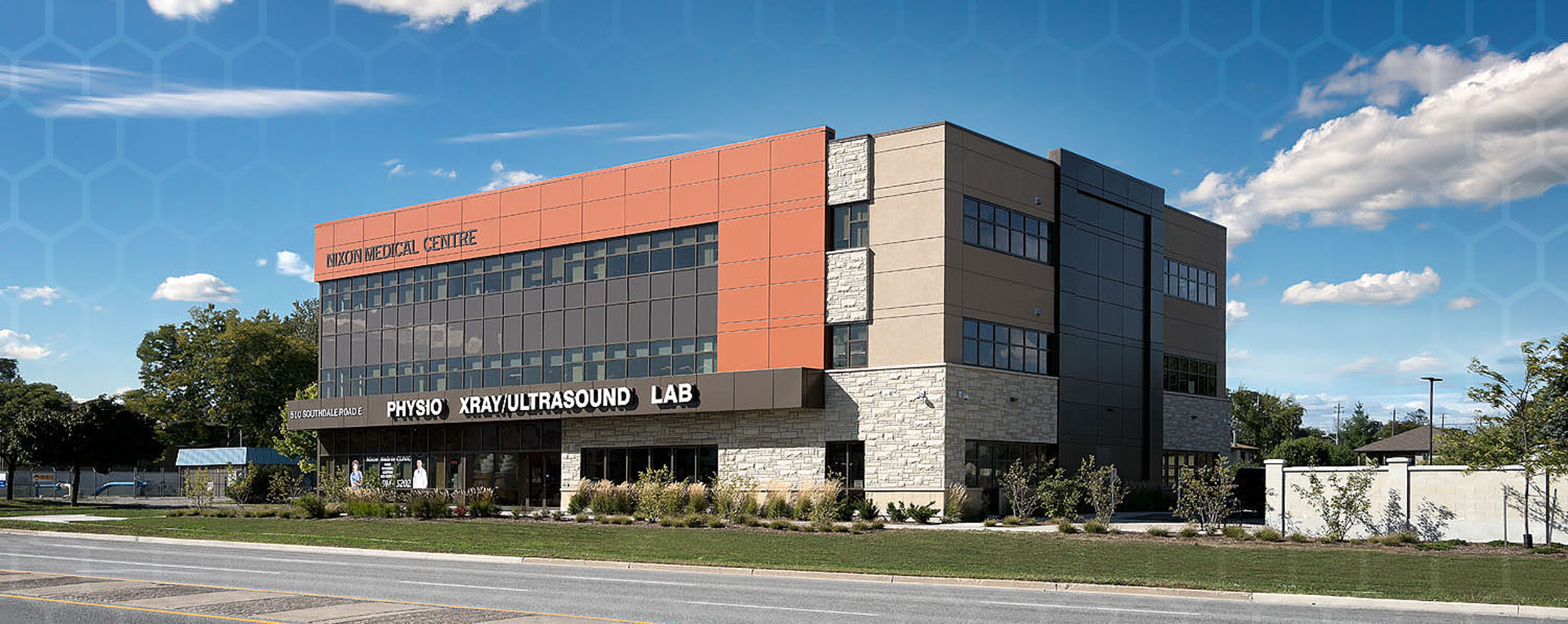 Nixon Medical, Exterior photo showing red brick walls accented with brown brick and glass