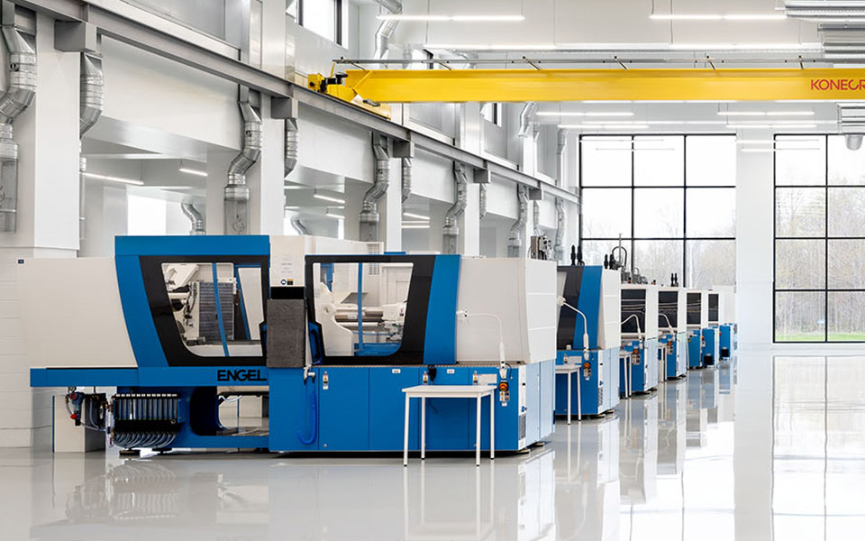 Row of robots on a manufacturing plant floor