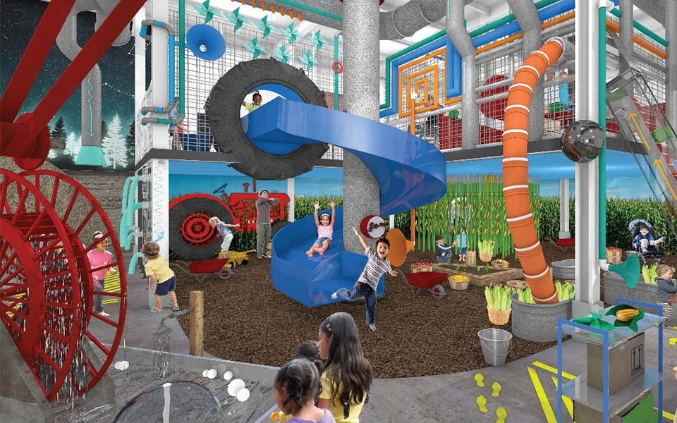 Children's museum, institutitional facility construction, children playing in a playroom with climbing structures and slides as well as a water area.