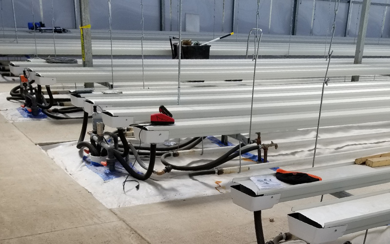 Interior photo showing the lighting system. rs on them, a sissor jack against the wall and fans hanging on the wall