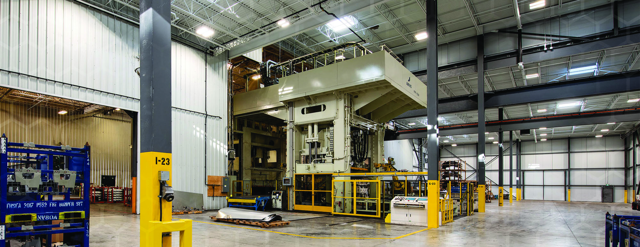Interior Photo of Amino Facility showing a large floor to ceiling industrial press