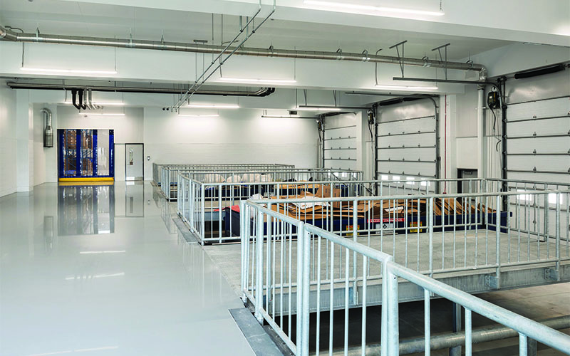 Startlim loading dock area with white steel railing around each loading area.