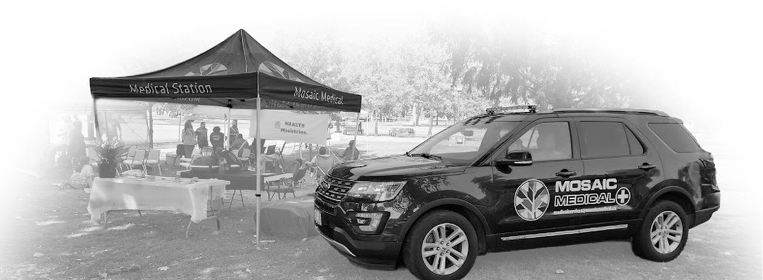 A black SUV with "Mosaic Medical" branding is parked beside a medical station tent. Tables and chairs are set up under the tent, creating a prepared and organized atmosphere.