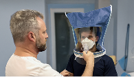 A Mosaic Medical staff member performing mask fitting on a client.