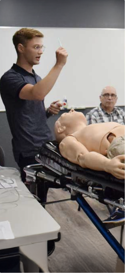 A Mosaic Medical employee instructing a class of students.