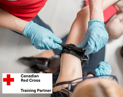 An instructor showing how to apply a tourniquet to a student.