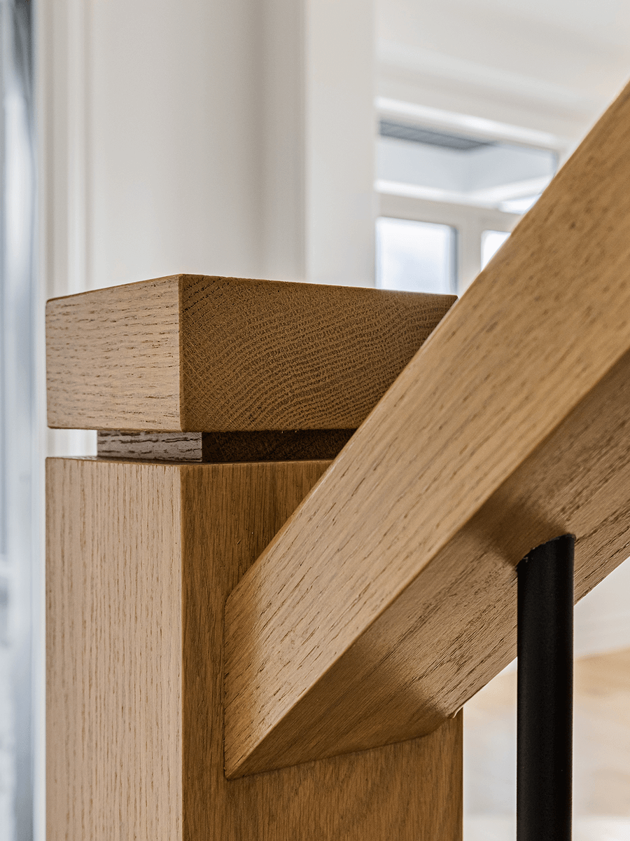 Interior stairs with oak posts and matte black balusters